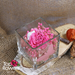 Elegant pink eternal rose in a glass container with a romantic look