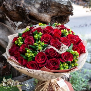 Round bouquet of 31 red roses with greenery