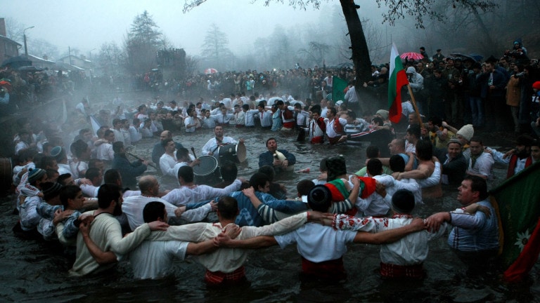epiphany traditions jordan. men dance in the icy waters