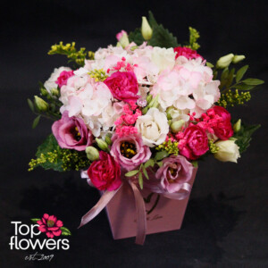“Midnight Kiss” arrangement with white hydrangea, pink eustomas, and burgundy mini carnations in a pink box