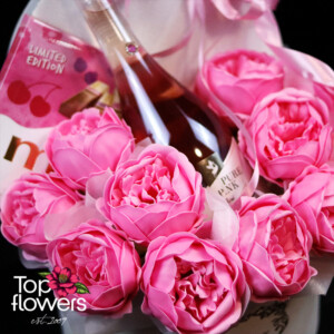 Box with pink peony soap roses and a bottle of rosé