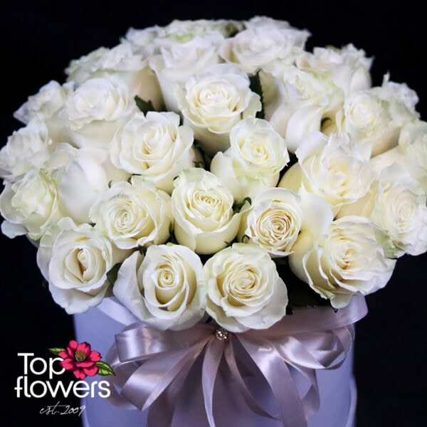 31 white roses arranged in a stylish tube with floral foam for freshness