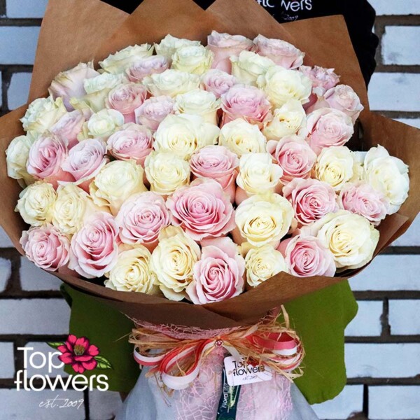 Delicate pink and white roses in a large bouquet of 51 stems