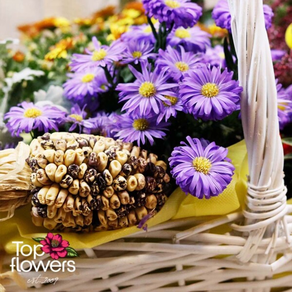 Purple asters and decorative corn in basket “Autumn Tale”
