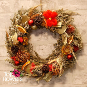 Detail of a Christmas wreath with pinecones and ornaments