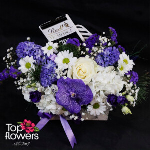 Overall view of a flower arrangement with chocolate – premium flower delivery