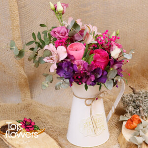 Lilac Garden - arrangement with rose, eustoma, and alstroemeria in a decorative metal watering can