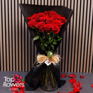 Red Explorer roses in stylish black floral wrapping