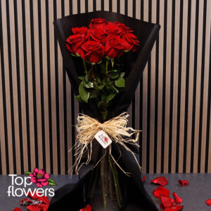 Red Explorer roses in stylish black floral wrapping