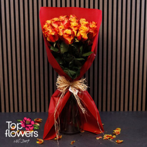 Fiery roses in red wrapping with a natural ribbon