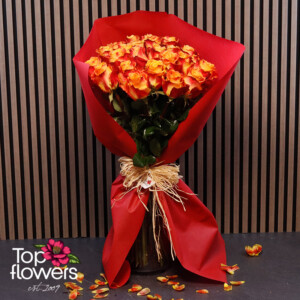 Fiery roses in red wrapping with a natural ribbon