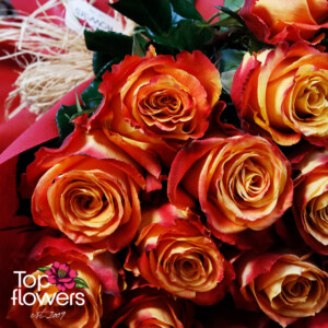 Elegant bouquet of fiery roses with red floral wrapping