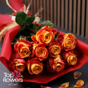 Elegant bouquet of fiery roses with red floral wrapping