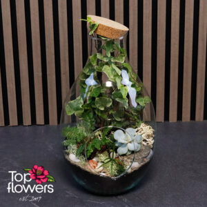 Flower Mix 9 with foliage plants and Scandinavian moss in a glass container