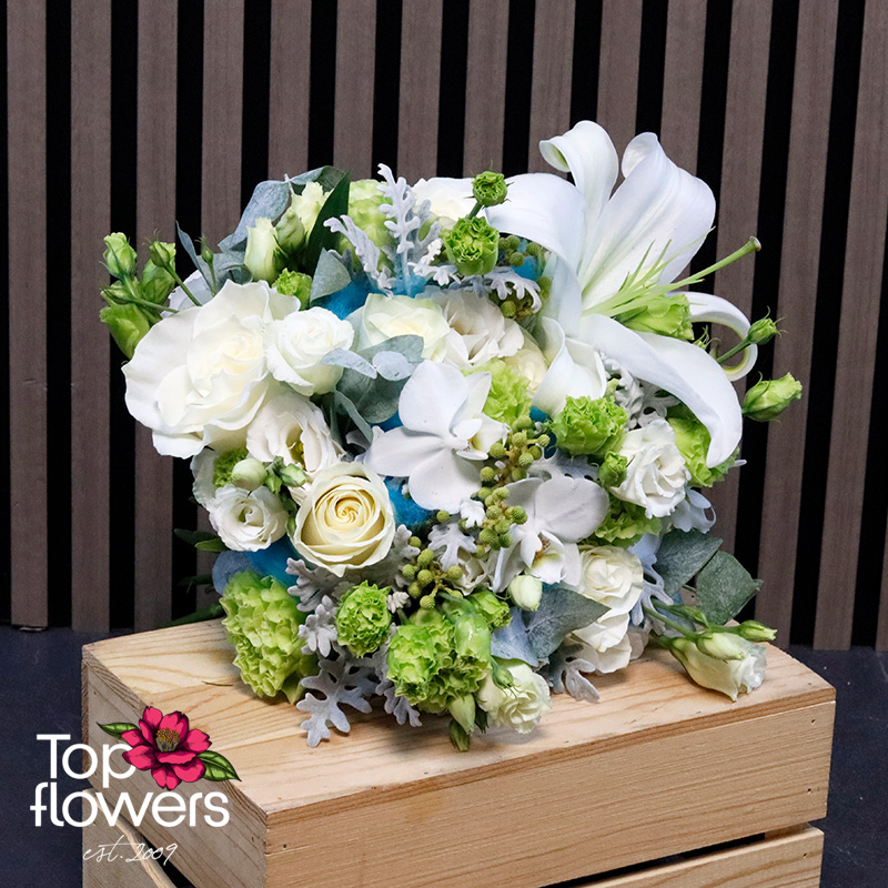 Oceana bridal bouquet with satin ribbon, white roses, and decorative greenery