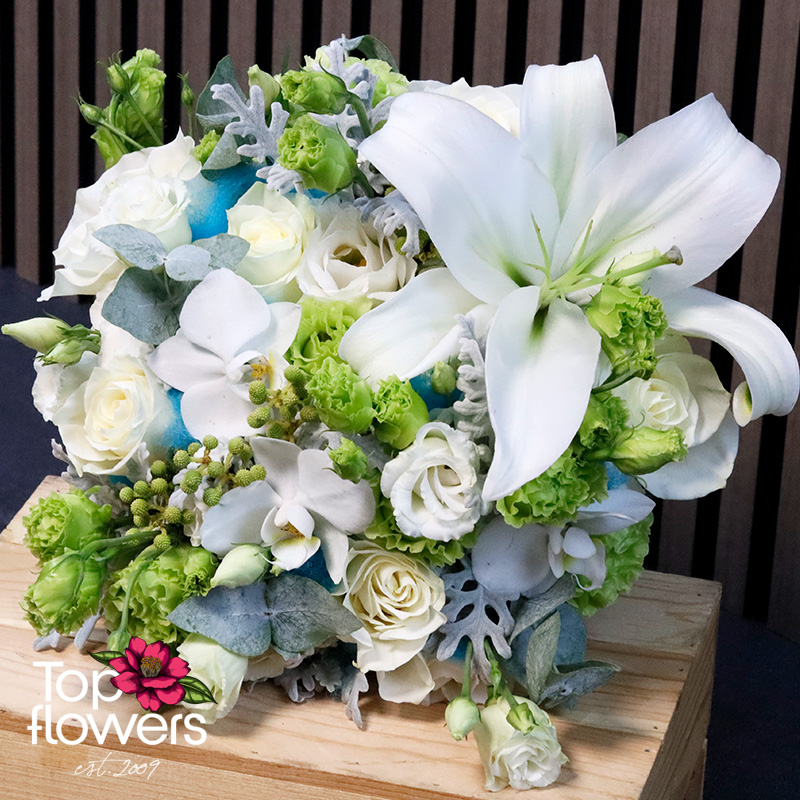 Close-up of Oceana bridal bouquet with lilies, orchid, roses, and lisianthus