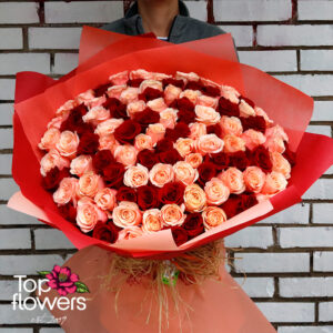 Bouquet of 101 red and peach roses with decorative wrapping