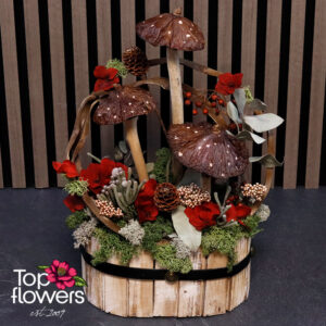 Close-up of the Under the Caps composition with Scandinavian moss, decorative mushrooms, pine cones, and red floral accents